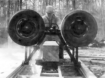 In order to build a log cabin on his woodlot, Pete Peterson first built a homemade sawmill from spare parts.